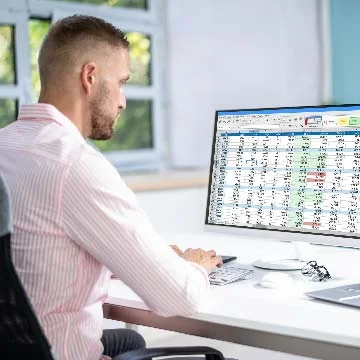 Employee entering medical codes into EHR software.